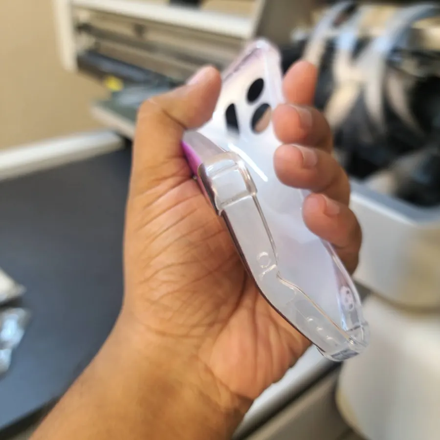 A clear case held up beside the printer and checked by hand
