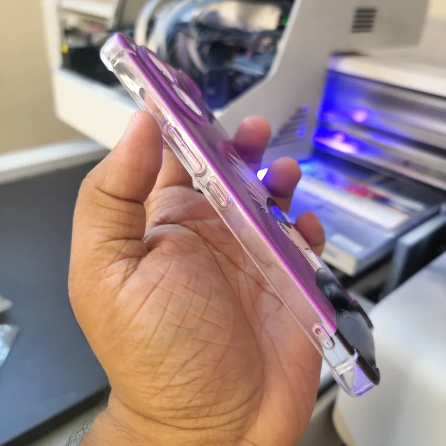 A freshly printed purple case held next to the printer
